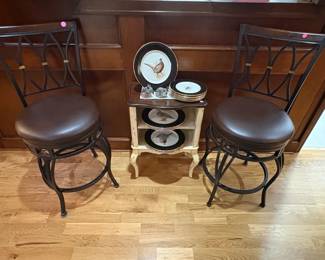 Nice pair of bar stools and a cute distressed 2-shelf table holding game bird plates.