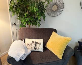 Another comfy chair holding a cute puppy pillow ( one of a pair).