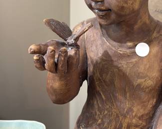 Large figure of child admiring butterfly