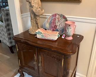 Nice end table, or night stand, displaying statuary and pottery.