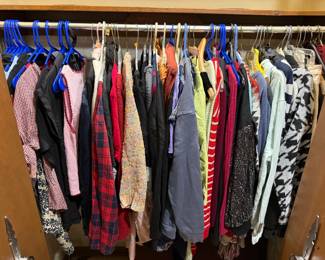 Lots of woman's clothing, various sizes and styles