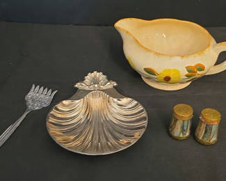 Lot 32: Floral ceramic creamer, shell-shaped metal dish, salt and pepper shakers, and ornate serving fork