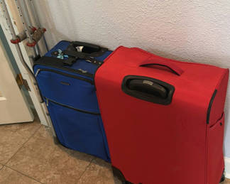 Lot 103: Red and Blue Rolling Suitcases