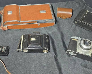 Lot 52: Vintage cameras and accessories in leather cases