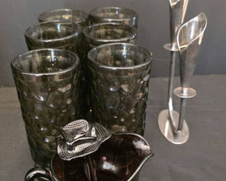 Lot 30: Six textured black glass tumblers with a matching black glass creamer and metal candleholders