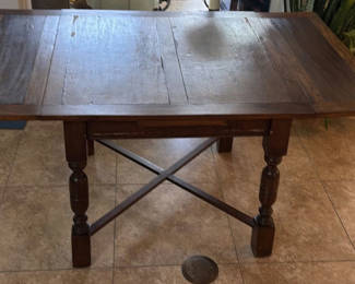 Lot 111: Dark wood dining table with panelled top and turned legs