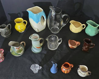 Lot 57: Collection of assorted ceramic pitchers, creamers, and small jugs