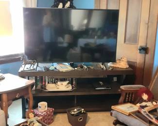 Newer drop leaf end table, one of a couple working TV's, Rocker with stool,      antique doll be, dolls and a ShirleyTemple 