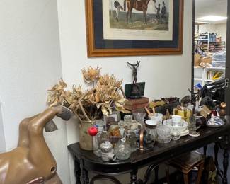 Horse prints, console table, shelves of stuff