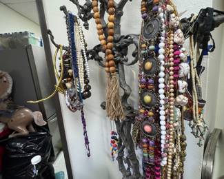 Antique iron hall tree loaded up with jewelry
