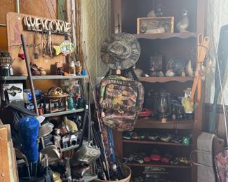 man cave stuff, fishing poles, toy cars, cameras, bow and arrow
