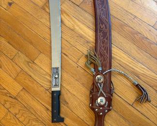 Vintage Collins & Co. machete accompanied by its highly decorative, hand-tooled leather sheath.