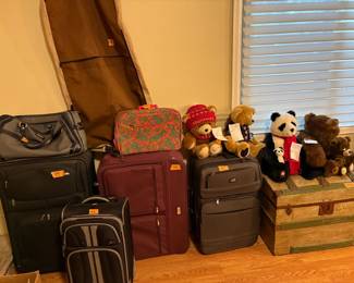 Luggage, teddy bears and domed steamer trunk