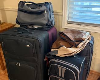 Assorted suitcases and travel accessories