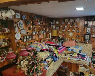 This cozy family room is filled with vintage quilts, handmade afghans, decorative plates, collectible mugs, holiday décor, table lamps, framed artwork, wall décor, and charming country home furnishings. Browse a wonderful selection of vintage collectibles, linens, seasonal decorations, and unique household treasures at this Danbury, CT private estate sale. Perfect for collectors, home decorators, antique enthusiasts, and anyone searching for one-of-a-kind estate sale finds. Everything must go!