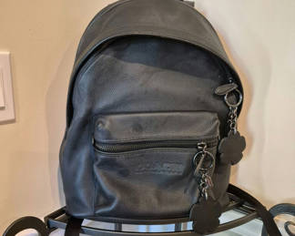 Lot 12: Coach black pebbled leather backpack with flower charms