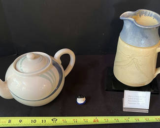 Lot 31: Ceramic teapot, blue-glazed jug, and Kokeshi doll with display plaque
