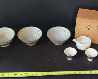 Lot 28: Japanese porcelain teaware set with plum-blossom glaze (bowls, cups, pitcher) and wooden boxes