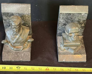 Lot 4: Stone bust bookend pair with skull and serpent motif