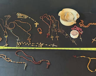 Lot 25: Assorted religious bead jewelry (rosaries and crucifix necklaces) with ceramic items