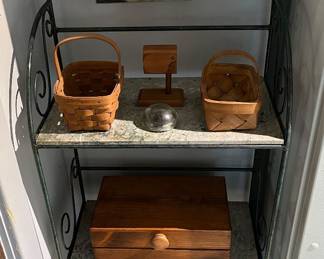 Wrought iron baker’s rack with marble shelves.