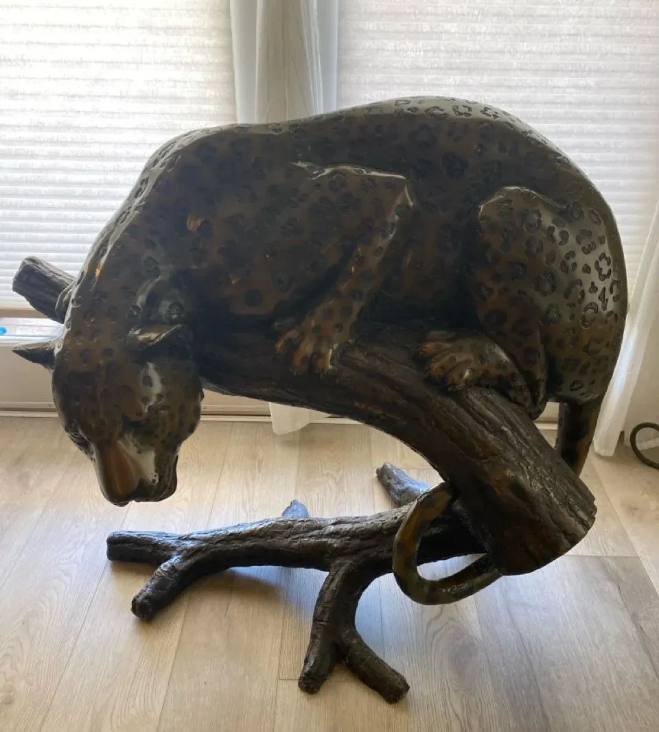 001 Bronze Leopard Perched On A Tree Branch