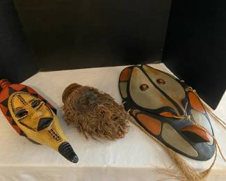 Celebrating Three Mask Hanging From Three Cultures