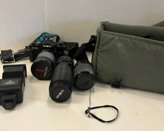 A Vintage Minolta X700 35mm SLR Film Camera And Some Extra Lenses And Flash