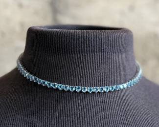 This lot features a stunning blue topaz jewelry collection set in sterling silver. One necklace that measures, 17” and a pair of tennis bracelets that are each 7”. This set was originally purchased for $1,200 and has a total approx. weight of 52.94 grams.
