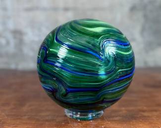 This lot features a stunning hand made blown glass float from Oregon Coast Taft circa 2018. This float measures, 7” H x 7” W.