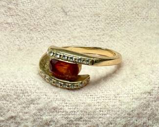 This lot features a 14k gold ring with a sunstone and genuine diamonds. Comes in a size 7 with a total approx. weight of 4.49 grams.
