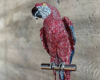 This lot features a stunning Macaw sculpture by listed artist, Jay Strongwater. Dazzling with over 1,000 hand set Swarovski crystals and sits on a plinth. Originally purchased from gallery for $14,000. Comes with additional crystals and repair kit to replace any missing crystals over time. The Macaw measures, 24” H and on the stand measures, 66” H.