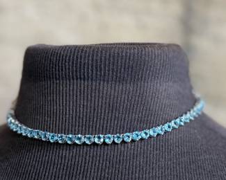This lot features a stunning blue topaz jewelry collection set in sterling silver. One necklace that measures, 17” and a pair of tennis bracelets that are each 7”. This set was originally purchased for $1,200 and has a total approx. weight of 52.94 grams.