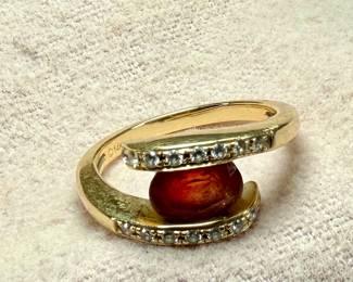 This lot features a 14k gold ring with a sunstone and genuine diamonds. Comes in a size 7 with a total approx. weight of 4.49 grams.