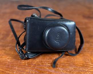 This lot features a Leica D-Lux 4, a classic 10.1-megapixel compact digital point-and-shoot camera released in 2008. It features a bright 24–60mm equivalent f/2.0–2.8 zoom lens, a 1/1.63-inch CCD sensor, and RAW image support.