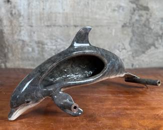 This lot features a stunning dolphin door handle, famously seen on doors when entering a Wyland gallery. Crafted from cast bronze with a rich, detailed patina finish. The handle measures, 19” W with 12” in between each screw mount.