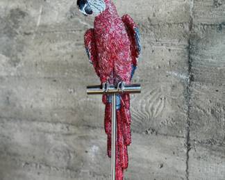This lot features a stunning Macaw sculpture by listed artist, Jay Strongwater. Dazzling with over 1,000 hand set Swarovski crystals and sits on a plinth. Originally purchased from gallery for $14,000. Comes with additional crystals and repair kit to replace any missing crystals over time. The Macaw measures, 24” H and on the stand measures, 66” H.