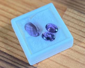 This lot features three (3) Amethyst gemstones with a total carat weight of 30.95. The pair measures 14mm x 10mm and the large stone at 20mm x 16mm.