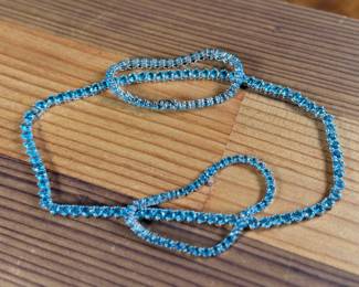 This lot features a stunning blue topaz jewelry collection set in sterling silver. One necklace that measures, 17” and a pair of tennis bracelets that are each 7”. This set was originally purchased for $1,200 and has a total approx. weight of 52.94 grams.