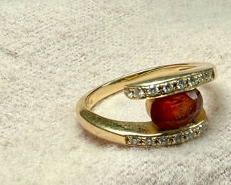 This lot features a 14k gold ring with a sunstone and genuine diamonds. Comes in a size 7 with a total approx. weight of 4.49 grams.
