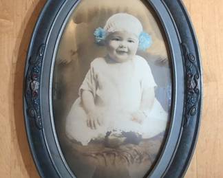 Antique baby photo in period oval frame with bubble glass (16” x 24”)