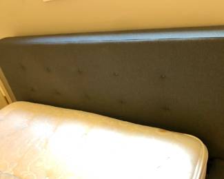 Detail of C & B Tate queen headboard - dark gray tufted fabric