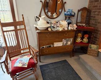 Vintage Wooden Upholstered Rocking Glider Chair; Antique Lowboy Dresser with Oval Mirror; 2 Vintage Wooden Dining Room Chairs; Pitcher & Cowl Set; Handpainted Floral Gone with the Wind Style Table Lamp; Avon Victorian Lady Figurines