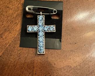 probably silver cross with blue stones