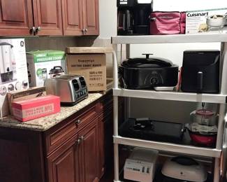 Cuisinart fondue set, Hamilton Beach crock pot, Hamilton Beach Flex Brew, Rival roaster oven, Cosori air fryer, West Bend griddle and popcorn maker, Ultrex deep fryer, GE electric skillet, coffee urn, pressure cooker, cotton candy maker, GE 4 slot toaster, Anchor Hocking, Pampered chef, KitchenAid roaster pan, Dash egg cooker, Oster waffle maker, Hamilton Beach 2 slice toaster
