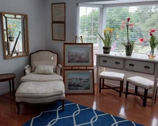 deep arm chair with ottoman, wall mirror, sofa table, upholstered benches, wall art, oval side table