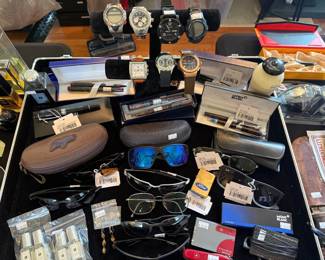 (A) Ray Ban Sunglasses, Ford Zippo Lighter, (B) Ray Ban Sunglasses, Mont Blanc Pen Set  