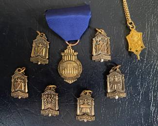 vintage school award pins and medals, featuring designs for scholarship, attendance, and music clubs