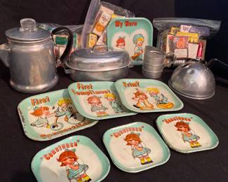 a vintage 1950s Ohio Art tin litho children's tea set featuring illustrations of a girl and doll