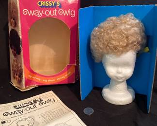 vintage Ideal Crissy's "Way-Out Wig" set, featuring a blonde curly doll wig on a stand with its original box and instructions